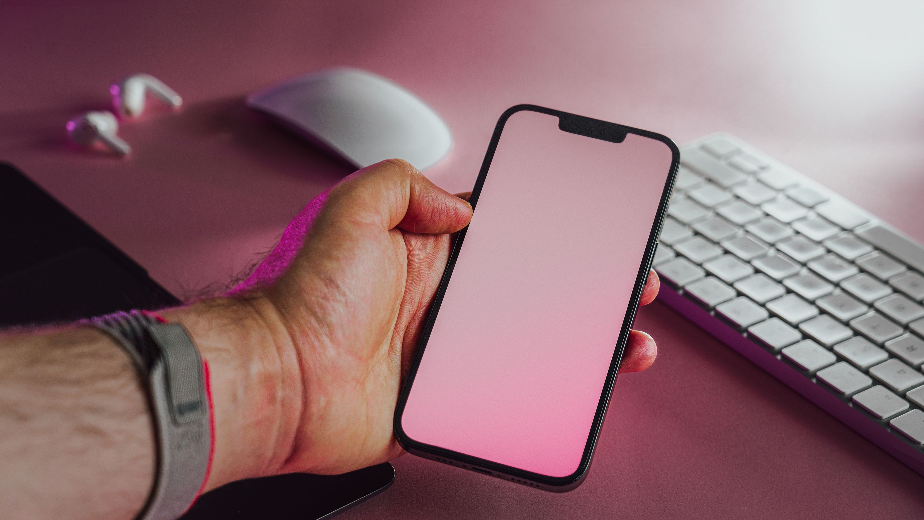 A mobile product shown in hand at a desk